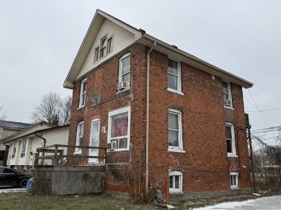 A red brick house with a white window trim.