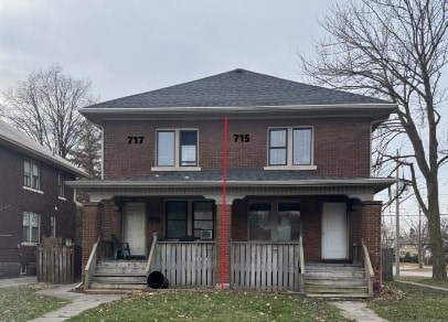 A two-story house with the numbers 717 and 715 on the front.