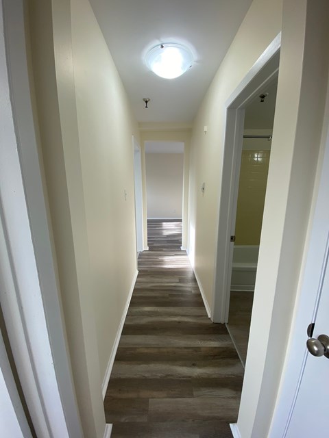 A long hallway with a light on the ceiling.