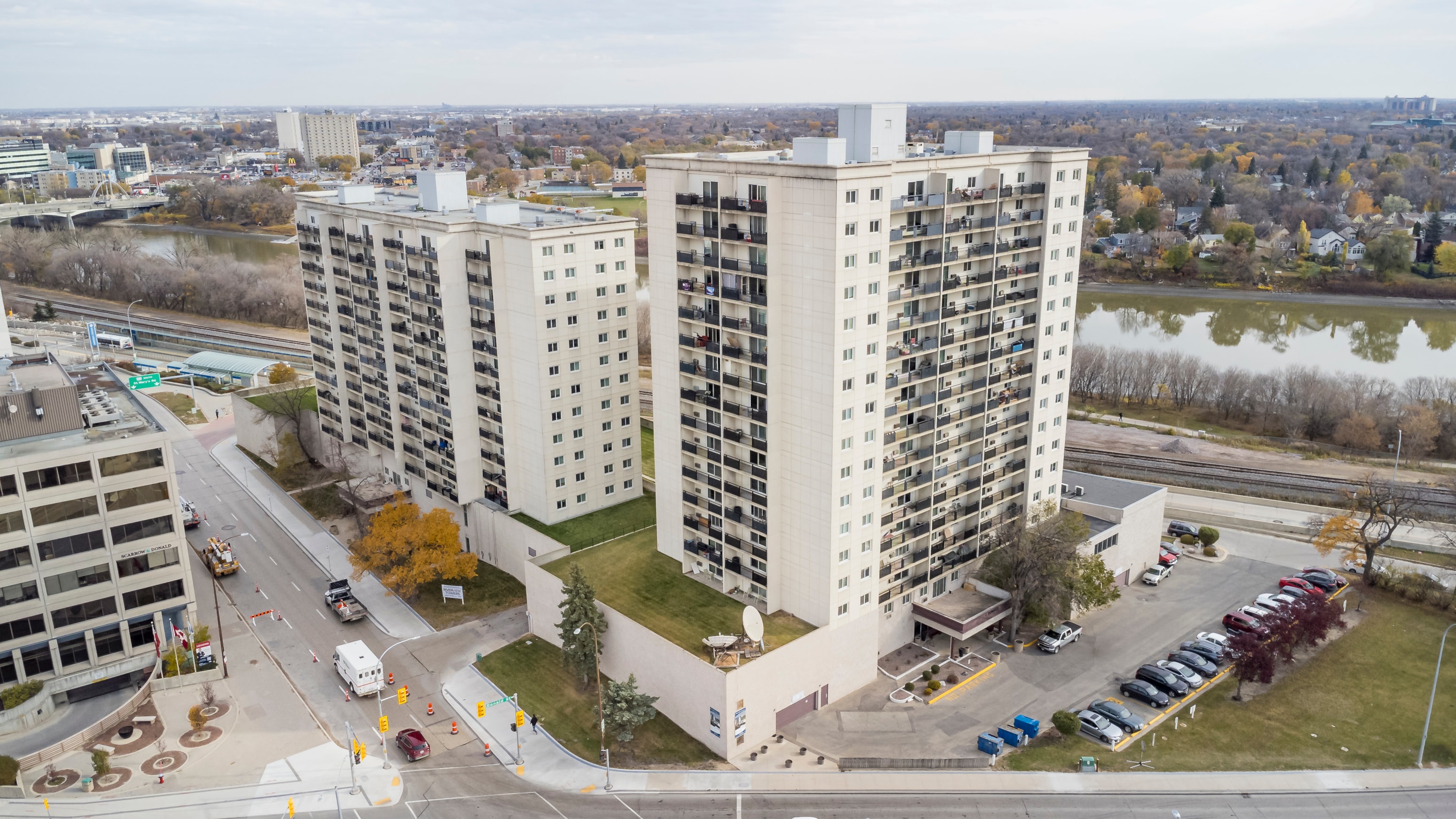 A large white building with a parking lot in front of it.