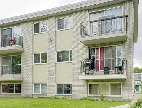 Apartment building with balconies and windows.