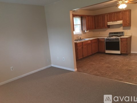 A kitchen with brown cabinets and a black stove top oven.