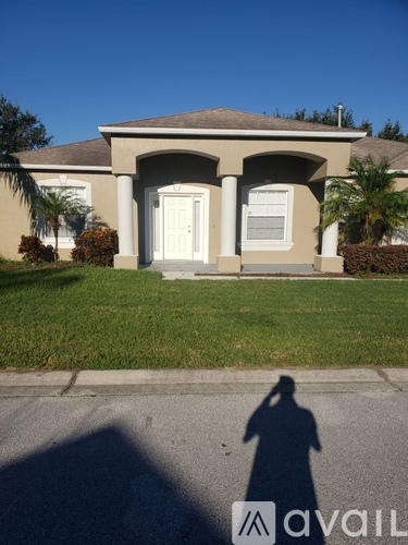 A house with a white door and a shadow of a person in front of it.