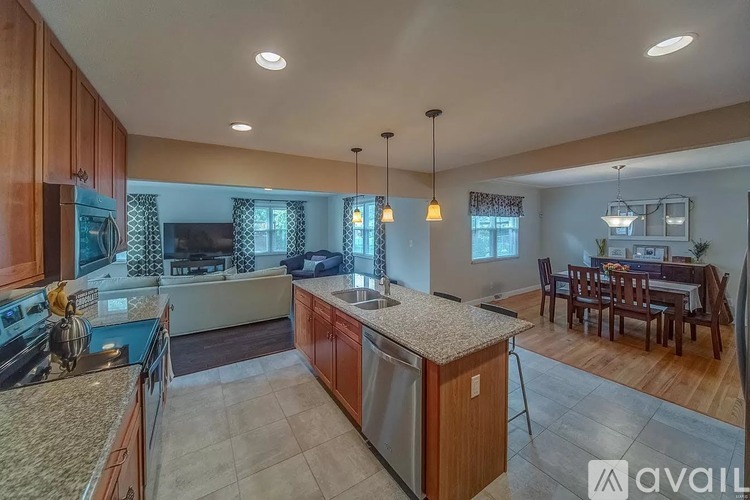 A kitchen with wooden cabinets and granite countertops.