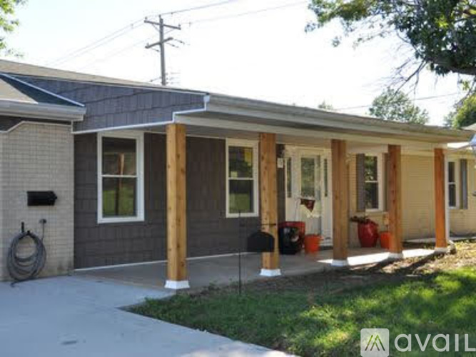 A house with a grey exterior and a wooden porch.