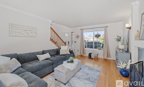 A living room with a grey sofa and a coffee table.