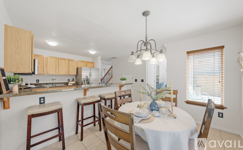 A kitchen with a dining table set for four.