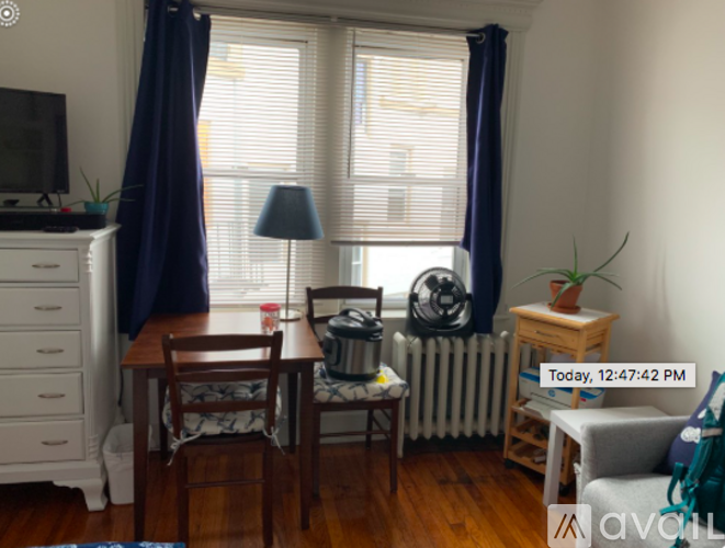 A room with a table, chairs, and a television.