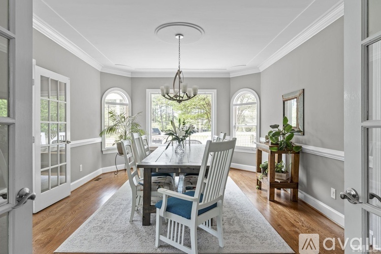 A dining room with a table set for six.
