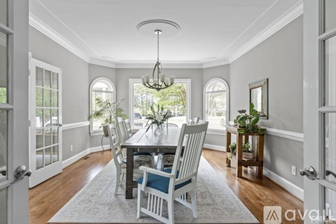 A dining room with a table set for six.
