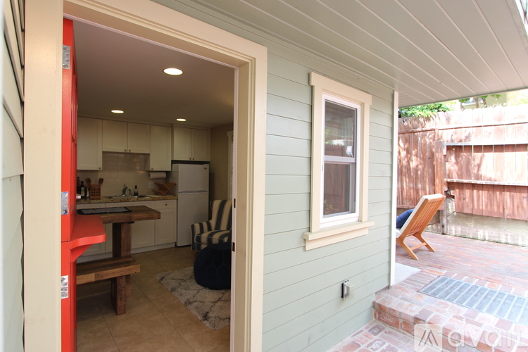 A kitchen with a refrigerator, sink, and cabinets is visible from the outside.