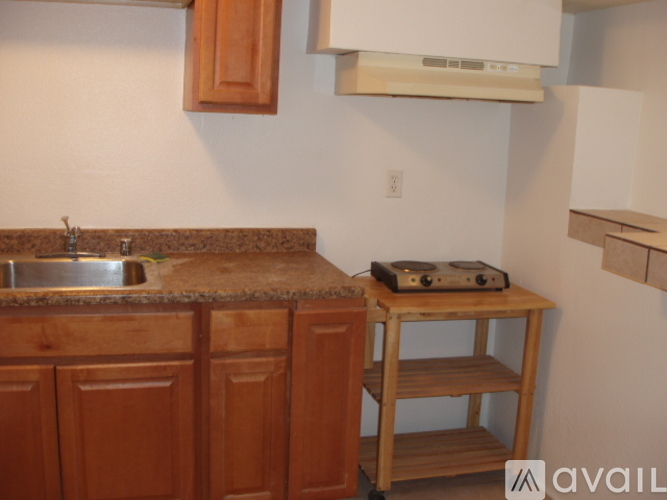 A kitchen with wooden cabinets and a granite countertop.