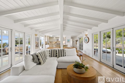 A living room with a white couch and a wooden coffee table.