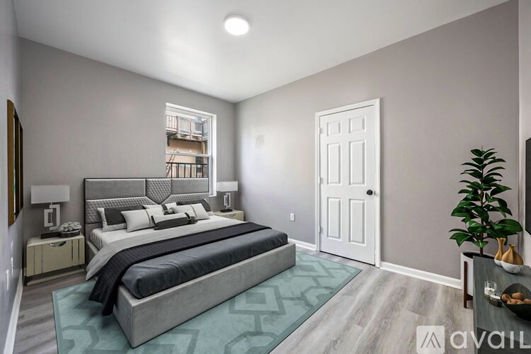 A bedroom with a large bed and a plant on the side table.