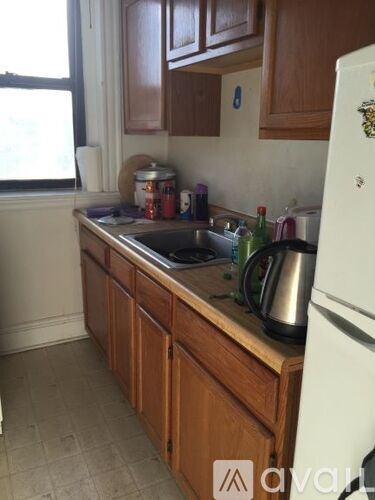 A kitchen with wooden cabinets and a white fridge.