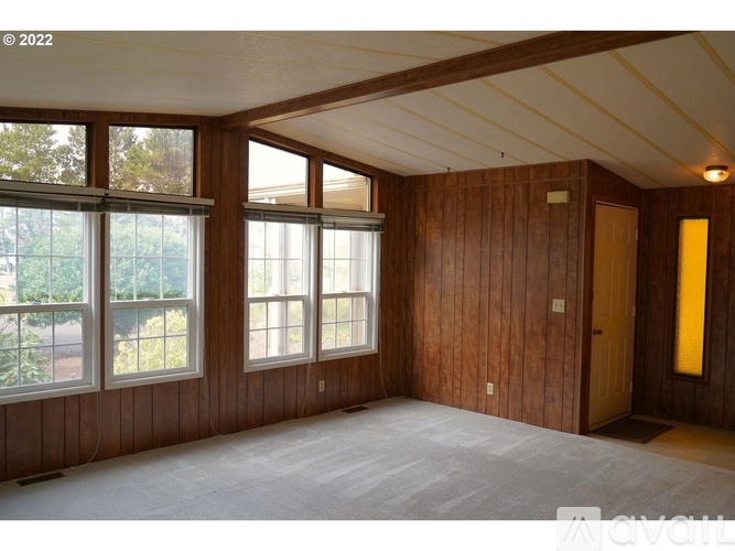 A room with wooden walls and a carpeted floor.