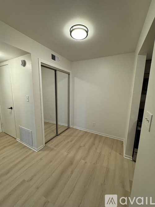 A room with a white door and a white wall.