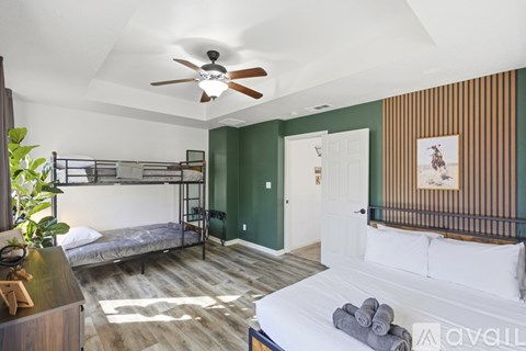 A bedroom with a bunk bed and a single bed.
