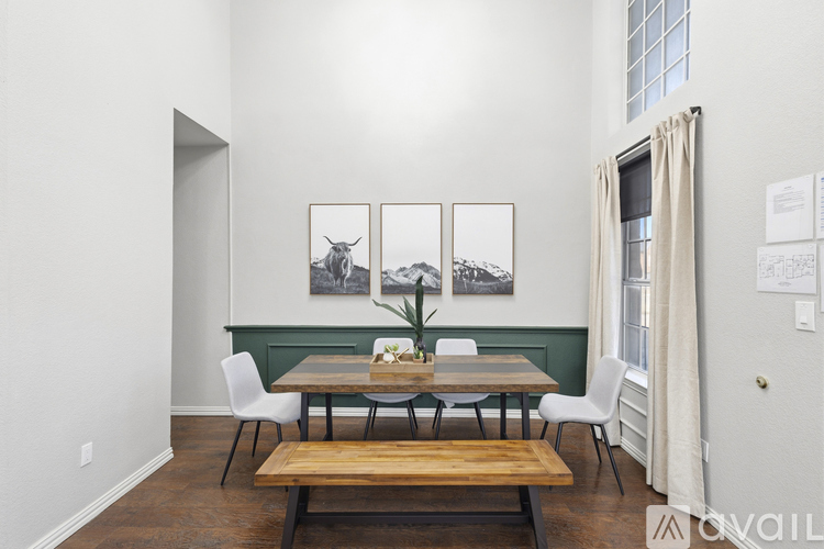 A dining room with a table and chairs.