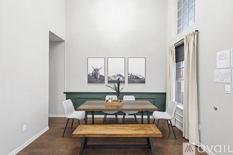 A dining room with a table and chairs.