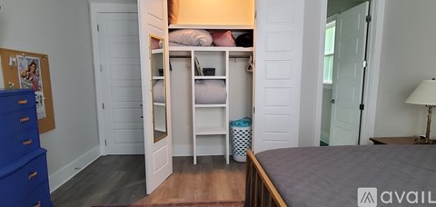 A bedroom with a blue dresser and a bunk bed.