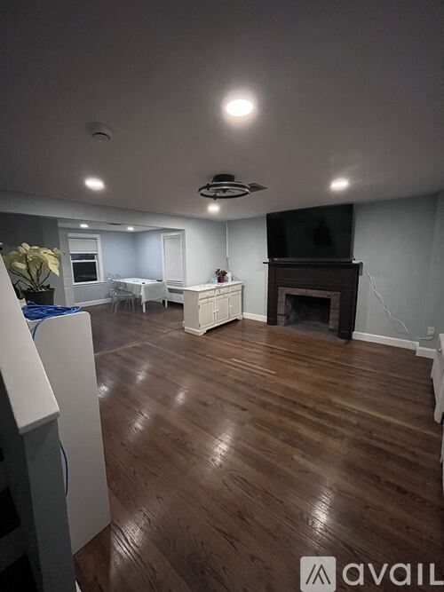 A living room with a fireplace and a television.