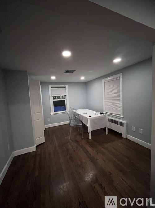 A room with a bed and a table in it.