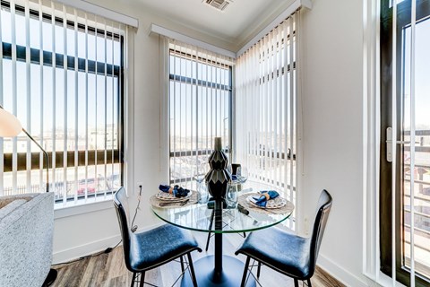 A dining room with a glass table and chairs.