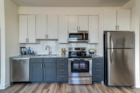 A kitchen with a stainless steel refrigerator and oven.