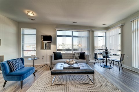 A living room with a blue chair and a coffee table.