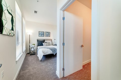 A bedroom with a bed and a painting on the wall.