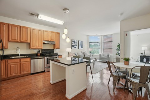 A kitchen with wooden cabinets and a black countertop.