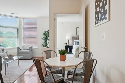 A dining room with a table and chairs.