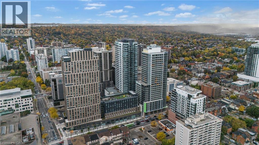 A cityscape with a mix of modern and older buildings, with a clear sky and some clouds.