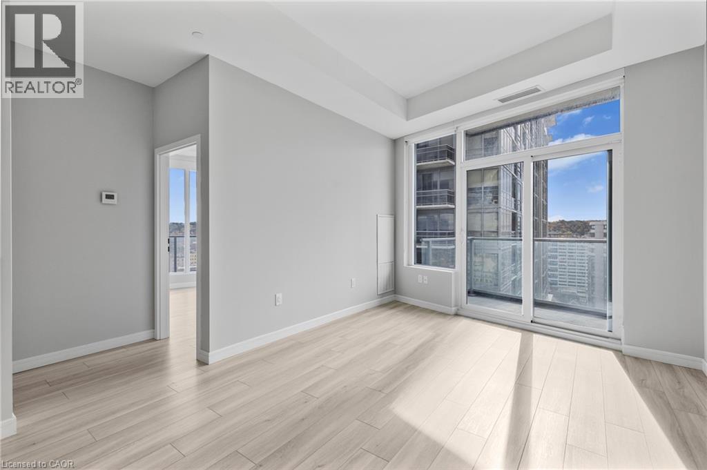 A spacious room with a large window and sliding glass doors.