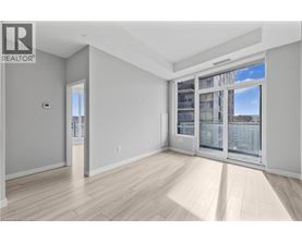 A spacious room with a large window and sliding glass doors.