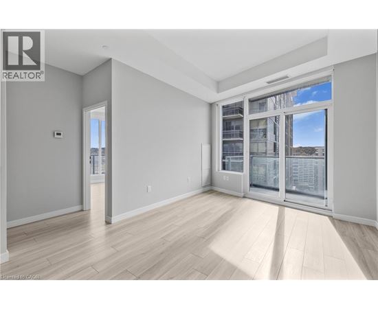 A spacious room with a large window and sliding glass doors.