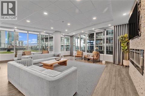 A spacious living room with a large grey sofa and a wooden coffee table.