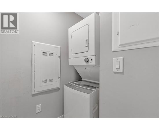 A white dishwasher and dryer in a kitchen.
