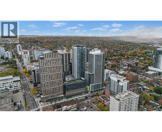 A cityscape with a mix of modern and older buildings, with a clear sky and some clouds.