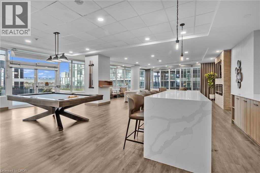 A spacious room with a pool table and a large marble table.