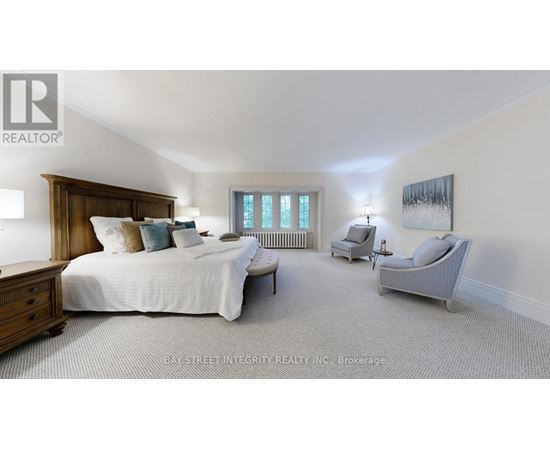 A bedroom with a large bed and a chair.