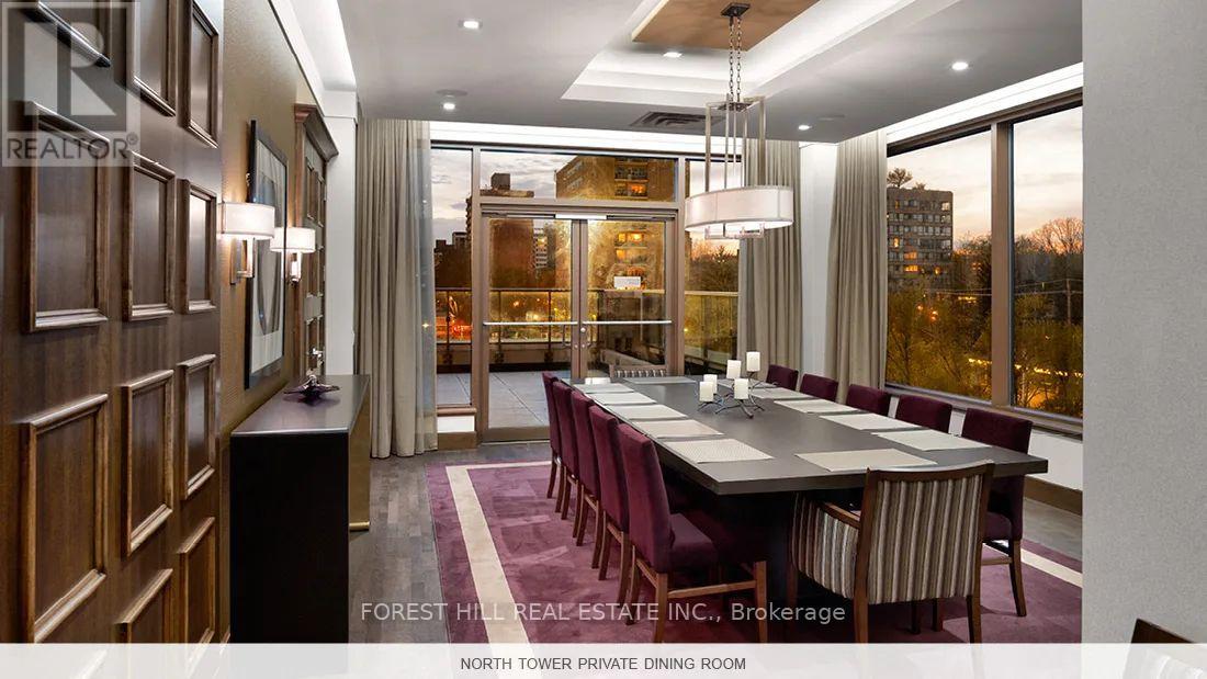 A dining room with a long table and chairs.