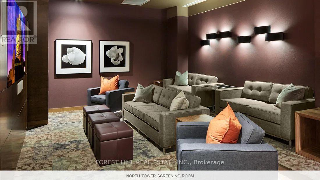 A living room with a couch, chair, and ottoman.