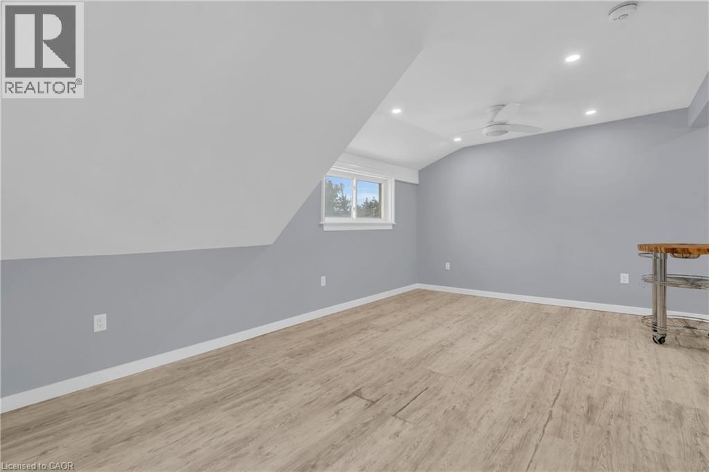 A room with wooden flooring and a window.