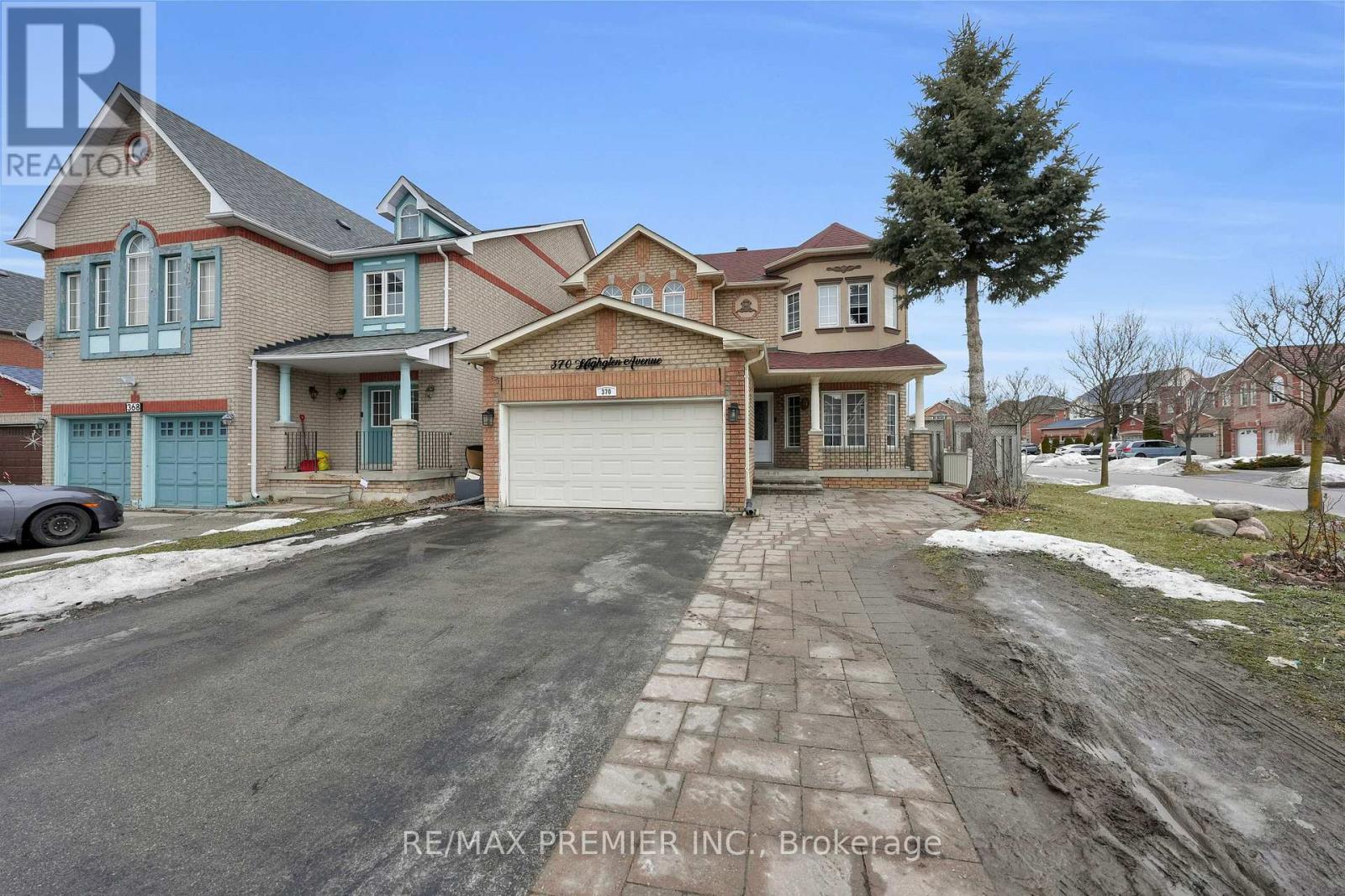 A large, multi-level house with a garage is for sale.