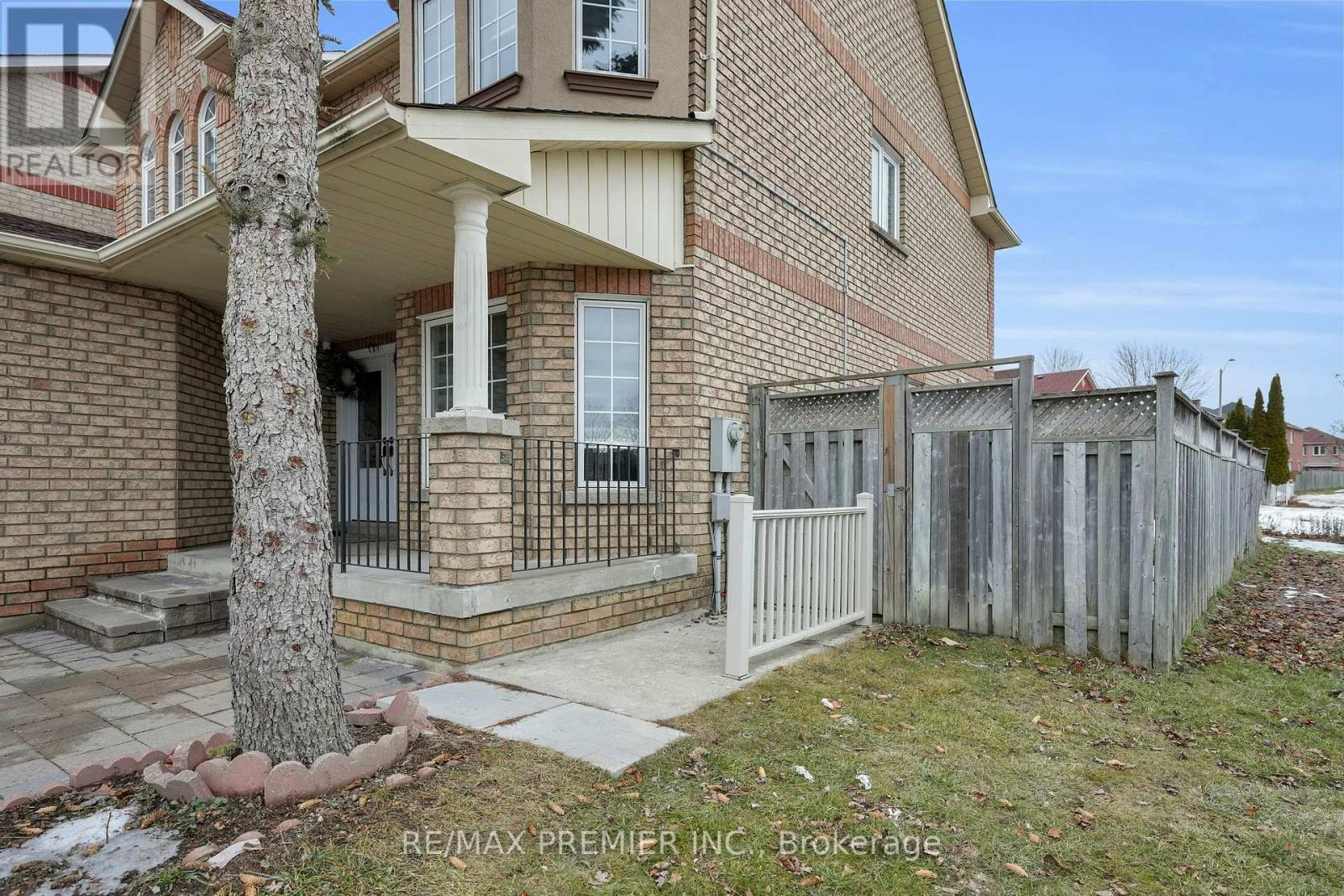 A house with a tree in front of it.