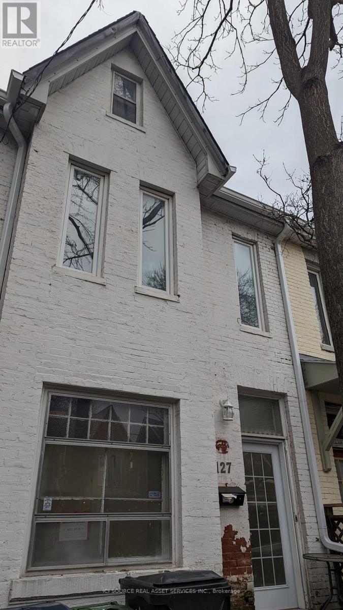 A white house with a black door and windows.