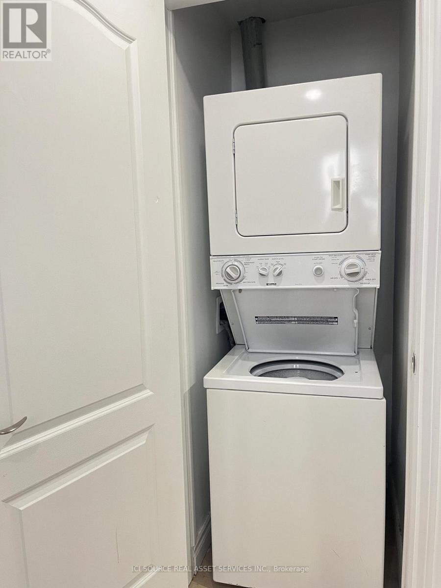 A white washer and dryer in a small space.
