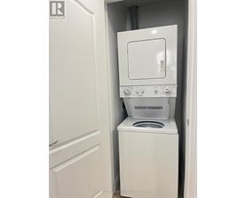 A white washer and dryer in a small space.